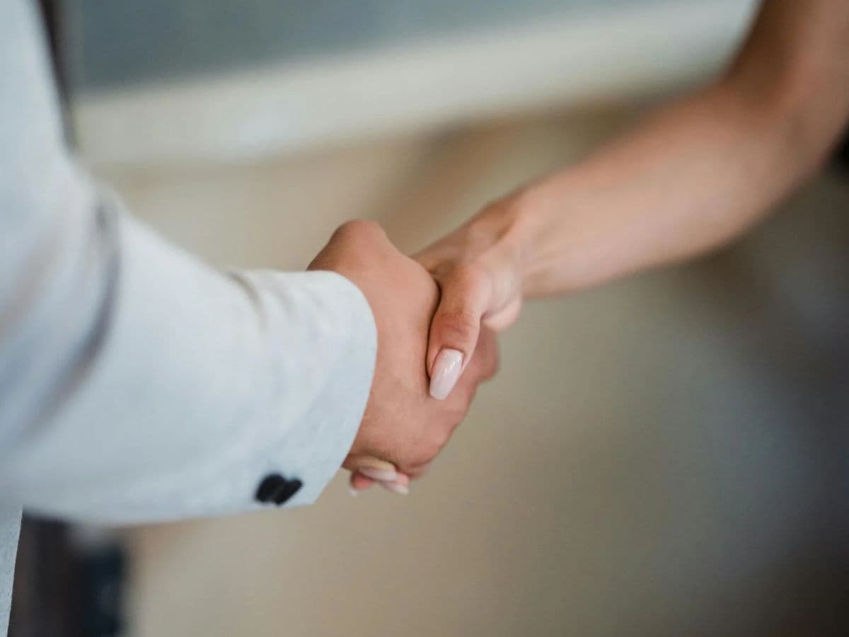 Two people shaking hands as they close a working agreement